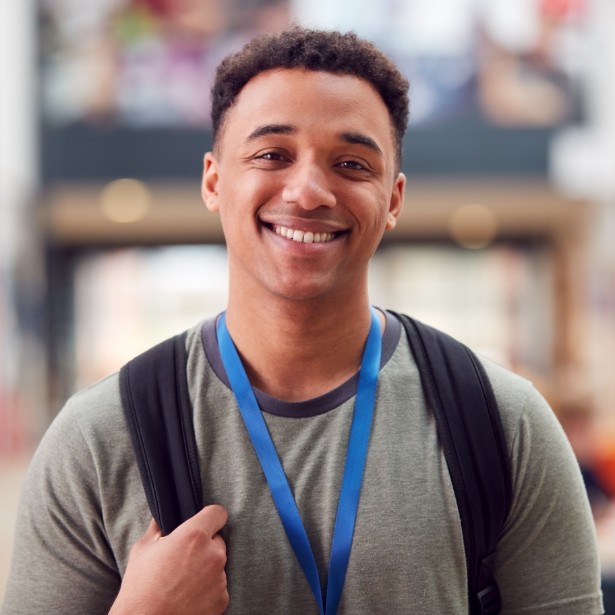 Young man smiling after integrative orthodontics treatment