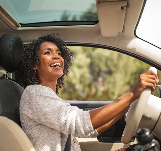 Woman smiling while driving