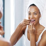 Woman smiling while flossing her teeth