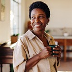 Smiling woman enjoying coffee at home