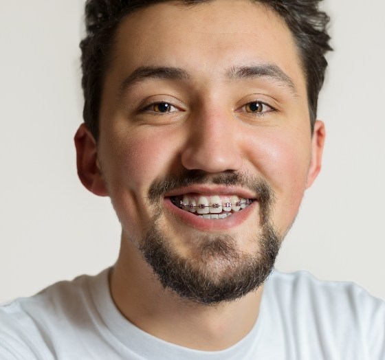 Man with adult orthodontics smiling