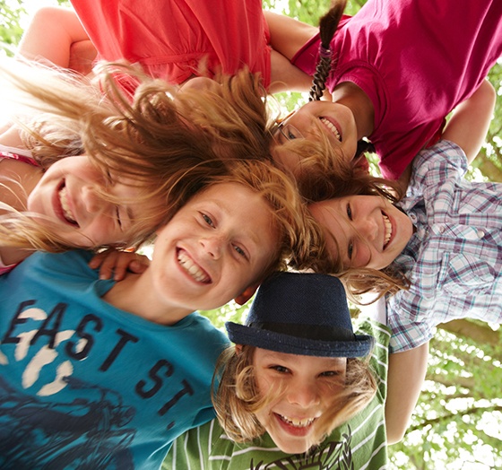 Group of kids smiling after airway orthodontics