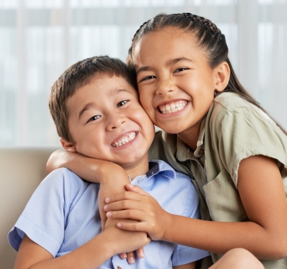 Two kids smiling after airway orthodontics treatment