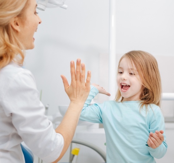 Child smiling during oral muscle therapy visit