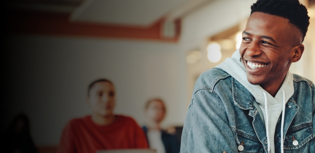 Laughing teenage boy in classroom