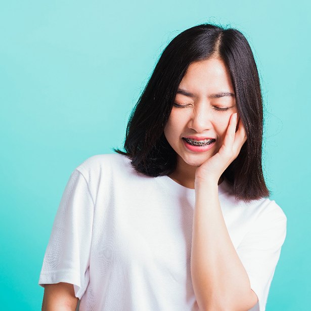 Girl on blue background with an orthodontic emergency in Palm Harbor