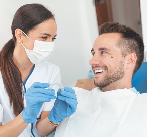Patient and dentist discussing the cost of Invisalign in Palm Harbor