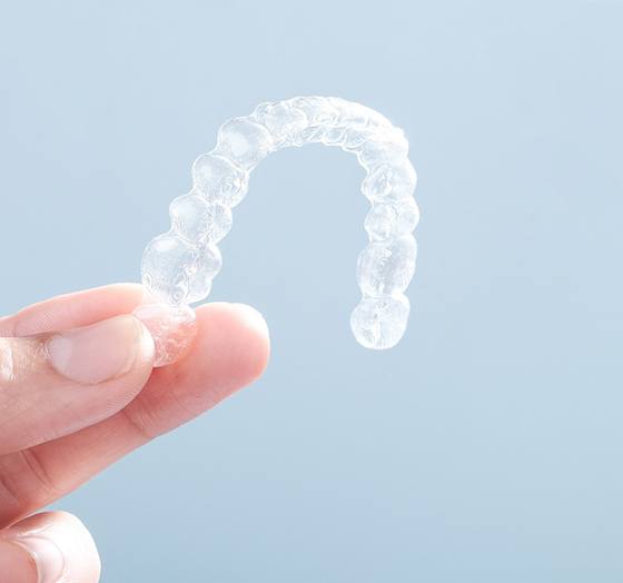 patient holding Invisalign aligner 