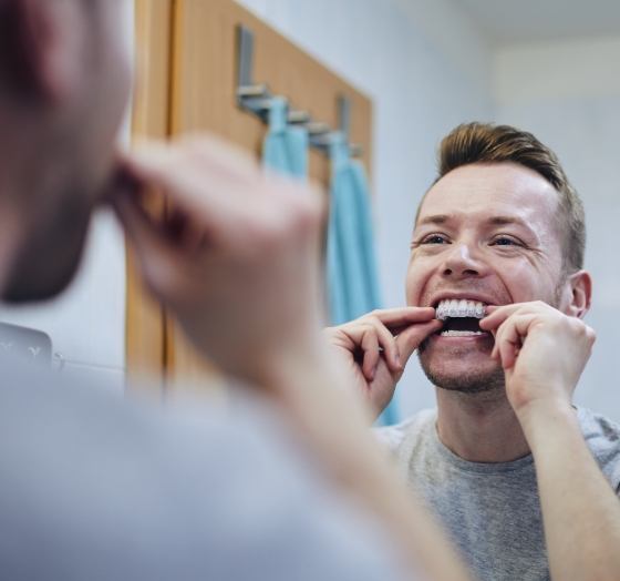 Man placing an Invisalign tray