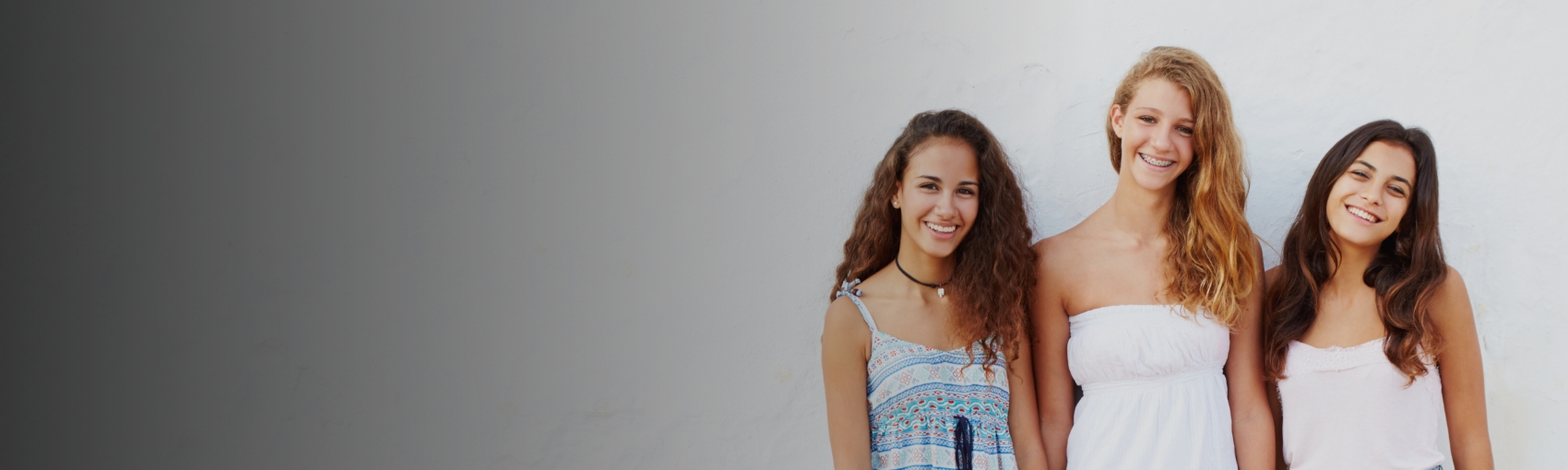 Three teen girls smiling after receiving orthodontic services in Palm Harbor Florida