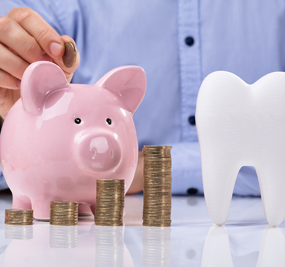 tooth and piggy bank for cost of traditional braces in Palm Harbor