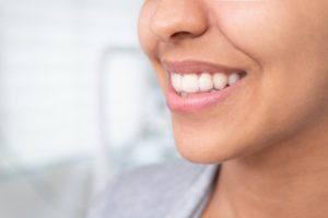 young woman holding clear aligner