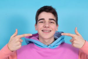 teen with braces smiling