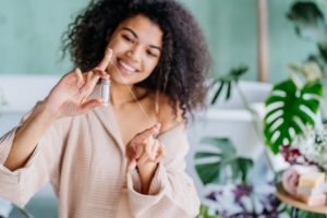 young woman flossing teeth