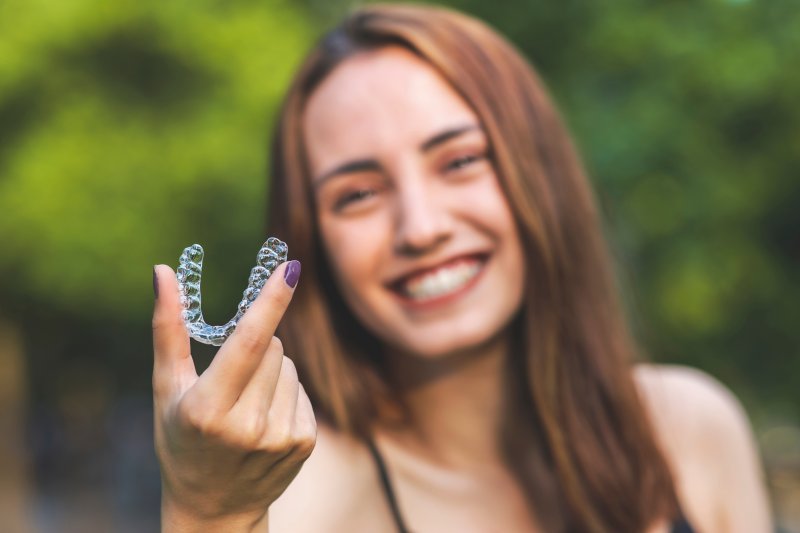 woman smiling with her aligner