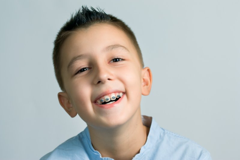 A young boy wearing metal braces 