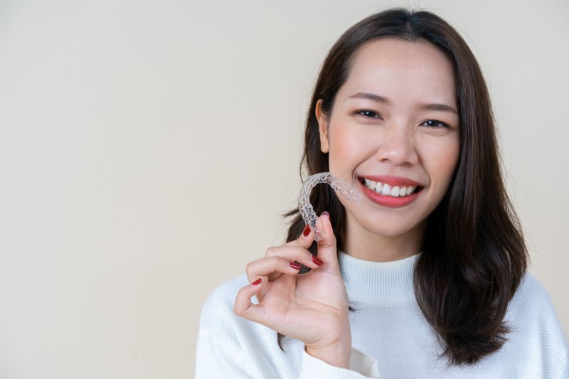 person holding clear aligner trays