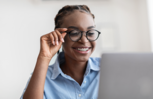 a person with braces smiling while using a laptop