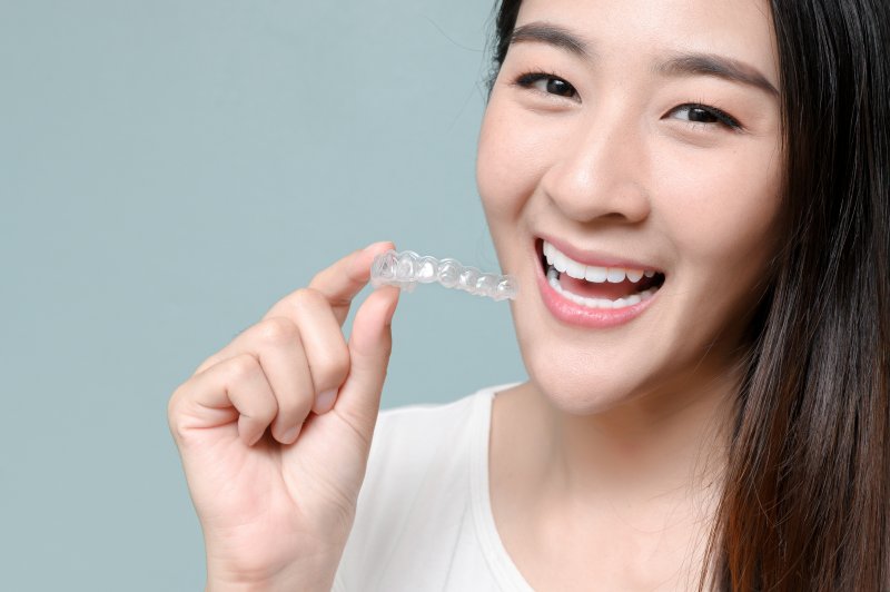 person inserting upper clear aligner