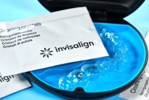Pack of Invisalign Cleaning Crystals with an aligner tray
