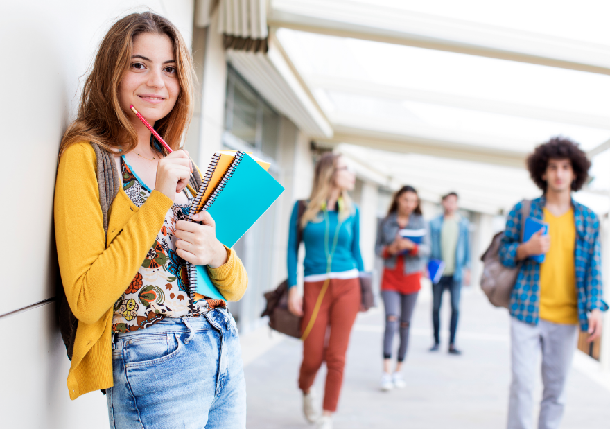 Highschool hallway with girl holding notebooks