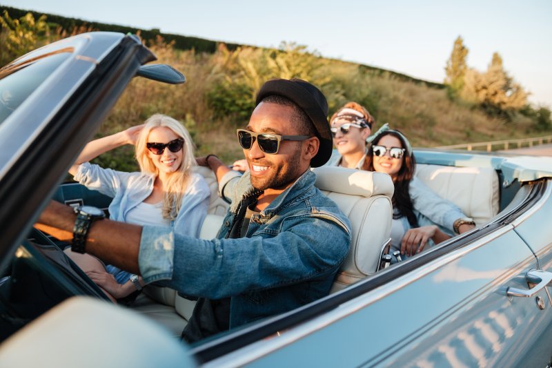 Invisalign patient smiling in the car with friends